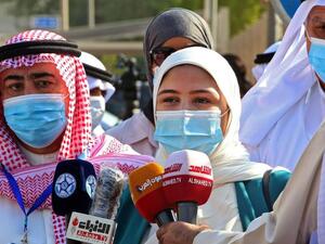 Candidate for the upcoming Kuwaiti parliamentary election Khadija al-Qallaf talks to reporters at the Department of Elections in Kuwait City on the first day of candidate registration. (AFP)