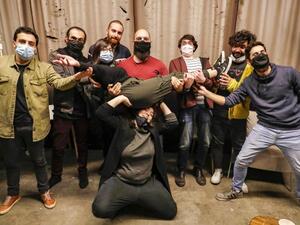 Stand-up comedians Mario Moubarak, Firas Shamieh, Mohammed Baalbaki, Nicolas Tawk, Iyad Al-Hout, Georges, and Georges pose for a picture behind Shaden (on her knees) and Lama Chmayaa (carried), in Beirut. (AFP)