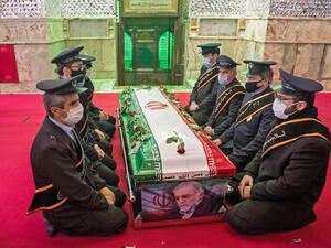 Members of the Iranian armed forces pray around the coffin of slain nuclear scientist Mohsen Fakhrizadeh during the burial ceremony in Tehran, on Nov. 30. HAMED MALEKPOUR/TASNIM NEWS/AFP VIA GETTY IMAGES