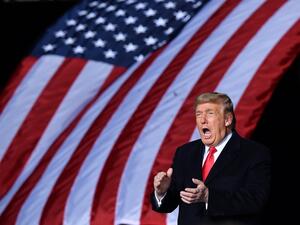 US President Donald Trump claps during a rally in support of Republican incumbent senators Kelly Loeffler and David Perdue ahead of Senate runoff in Dalton, Georgia on January 4, 2021. President Donald Trump, still seeking ways to reverse his election defeat, and President-elect Joe Biden converge on Georgia on Monday for dueling rallies on the eve of runoff votes that will decide control of the US Senate. MANDEL NGAN / AFP