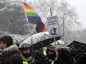 A protester holds a placard during a so-called "march of freedoms" to protest against the 'global security' draft law that would restrict publication of pictures showing the faces of police officers on duty on January 16, 2021 in Lille. DENIS CHARLET / AFP