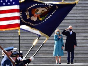 US President Joe Biden salutes as First Lady Jill Biden puts her hand on her heart as they review the readiness of military troops in a pass in review on the east steps of the US Capitol in Washington, DC, on January 20, 2021, after being sworn in at the US Capitol. David Tulis / POOL / AFP