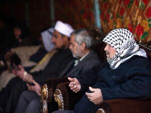 People console Louai al-Nuaimi (R), father of two Iraqi youngsters, Omar and Ali, killed in Baghdad's twin suicide attacks, during a condolences ceremony in the capital's Cairo neighbourhood, on January 22, 2021. Twin suicide blasts in Baghdad claimed by the Islamic State group have exposed gaps within Iraq's security forces, weakened by the COVID-19 pandemic, rival armed groups and political tensions. Ayman HENNA / AFP