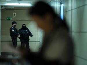 Police officers are seen in a hallway of a business centre, which houses the office of opposition leader Alexei Navalny's Anti-Corruption Foundation (FBK), in Moscow on January 27, 2021. Russian authorities on January 27 ramped up pressure on the opposition, searching the apartments and offices of jailed Kremlin critic Alexei Navalny ahead of new protests called for the weekend to demand his release. Ivan Zhdanov, the head of Navalny's FBK Anti-Corruption Foundation, said police were searching flats linked 