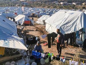 In this file photo taken on December 19, 2020 a migrant couple hang out their laundry outside their tent, in the new refugee camp of Kara Tepe, in the Greek island of Lesbos. The UN voiced alarm on January 28, 2021 at increasingly frequent pushbacks and expulsions of refugees at Europe's borders, warning that the very idea of asylum itself was under attack on the continent. Anthi PAZIANOU / AFP