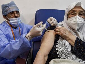 A medical worker administers a dose of Russia's Sputnik V vaccine for COVID-19 coronavirus disease upon a woman at a clinic in the city of Blida, about 45 kilometres southwest of the Algerian capital, on January 30, 2021, where the North African country is symbolically starting its vaccination drive at the same place to have registered the first novel coronavirus case in 2020. At the end of December, Algiers announced an order of 500,000 doses of Sputnik V vaccine from its Russian ally. RYAD KRAMDI / AFP