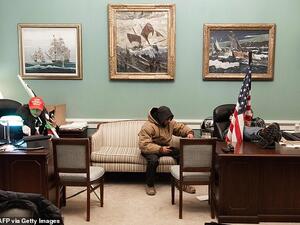 Trump supporters in their MAGA caps played with Pelosi's office furniture. (AFP)