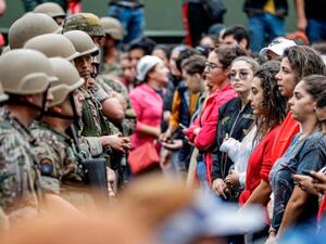 Female protesters stand in a line before Lebanese army soldiers during a demonstration on the seventh day of unrest against tax increases and official corruption, in Zouk Mosbeh, north of Beirut. AFP