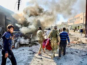 Pro-Turkish Syrian fighters carry away victim of car-bomb explosion last November in Tal Abyad, which has seen several such attacks (AFP)