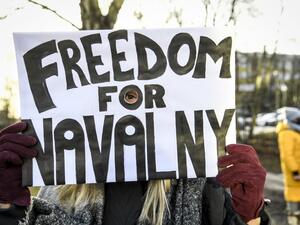 A demonstrator demanding the release of the detained Russian opposition leader Alexei Navalny holds a placard outside the Russian embassy in Stockholm, Sweden, on January 23, 2021. The 44-year-old Chief Kremlin critic Alexei Navalny was arrested at his return in Moscow after spending several months in Germany recovering from a poisoning attack that he said was carried out on the orders of President Vladimir Putin Fredrik SANDBERG / TT News Agency / AFP