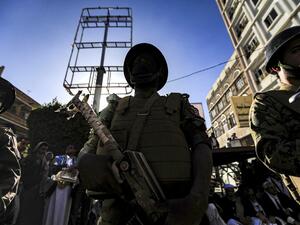 A member of security forces loyal to Yemen's Huthi rebels stands guard as supporters attend a rally denouncing the United States and the outgoing Trump administration's decision to apply the "terrorist" designation to the Iran-backed movement, in the Huthi-held capital Sanaa on January 25, 2021. Mohammed HUWAIS / AFP