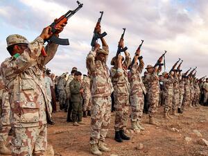 In this file photo taken on November 01, 2020 fighters fire salutatory rounds in the air during the funeral of General Wanis Bukhamada, commander of the "Saiqa" (Special Forces) of the self-proclaimed Libyan National Army (LNA) loyal to strongman Khalifa Haftar, in the eastern city of Benghazi. The United States on January 28, 2021 called for the immediate withdrawal of Russian and Turkish forces from Libya, after a deadline for them to leave was ignored. Abdullah DOMA / AFP