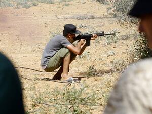 In this file photo taken on June 19, 2019 a fighter loyal to the internationally-recognised Libyan Government of National Accord (GNA) holds a rifle from a position in the al-Sawani area south of the Libyan capital Tripoli during clashes with forces loyal to strongman Khalifa Haftar. Mahmud TURKIA / AFP