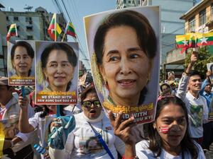 In this file photo taken on December 10, 2019 people participate in a rally in support of Myanmar's State Counsellor Aung San Suu Kyi, as she prepares to defend Myanmar at the International Court of Justice in The Hague against accusations of genocide against Rohingya Muslims. Myanmar's military has detained the country's de facto leader Aung San Suu Kyi and the country's president in a coup, a spokesman for her ruling party said February 1, 2021.  Sai Aung Main / AFP