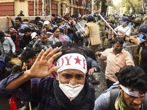 Leftist activists disperse as police baton charge during a protest against different policies of the Trinamool Congress (TMC) led state and Bharatiya Janata Party (BJP) led central government, in Kolkata on February 11, 2021. Dibyangshu SARKAR / AFP