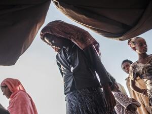 Internally Displaced People (IDP), fleeing from violence in the Metekel zone in Western Ethiopia, gather outside a tent where clothes are being distributed at a camp in Chagni, Ethiopia, on January 27, 2021. Inter-ethnic violence in Ethiopia's west -- concentrated in a lowland area known as Metekel -- predates a brutal three-month-old conflict farther north pitting Prime Minister Abiy Ahmed's government against the former ruling party of the Tigray region.  EDUARDO SOTERAS / AFP