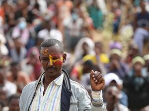 An Ethiopian refugee attends a gathering to celebrate the 46th anniversary of the Tigray People's Liberation Front at Um Raquba refugee camp in Gedaref, eastern Sudan, on February 19, 2021. In remote eastern Sudan, refugee activists are keeping the flame burning for the former rebels who dominated Ethiopian politics before being ousted from their regional stronghold of Tigray last year. Hussein Ery / AFP