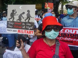 Protesters hold signs as they take part in a demonstration against the military coup in front of the Indonesian embassy in Yangon on February 23, 2021. Sai Aung Main / AFP