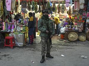 Indian paramilitary trooper stands guard along a street following an attack which killed two policemen last week, in Srinagar on February 24, 2021. TAUSEEF MUSTAFA / AFP
