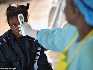 A girl suspected of being infected with the Ebola virus having her temperature checked at the government hospital in Kenema, Sierra Leone, in August 2014. (AFP/File)
