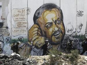 A mural depicts Marwan Barghouti at the Israeli Qalandiya checkpoint between Jerusalem and Ramallah in the occupied West Bank (AFP)