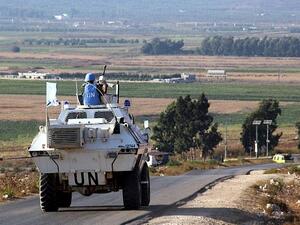 UN vehicles monitor the blue line 