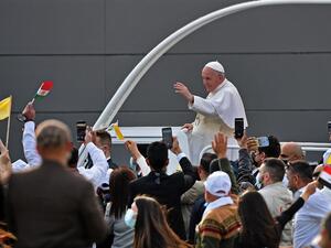 Pope Francis blesses people as he arrives in the popemobile vehicle at the Franso Hariri Stadium in Arbil, on March 7, 2021, in the capital of the northern Iraqi Kurdish autonomous region. Pope Francis, on his historic Iraq tour, visits today Christian communities that endured the brutality of the Islamic State group until the jihadists' "caliphate" was defeated three years ago. Vincenzo PINTO / AFP