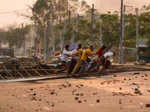 People run past makeshift barricades 