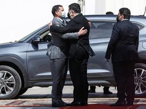 Mohamed al-Manfi (R), head of Libya's presidency council looks on as new interim Prime Minister Abdul Hamid Dbeibah (L) 