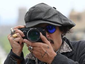 Johnny Depp poses during the photocall of the film "Minamata"