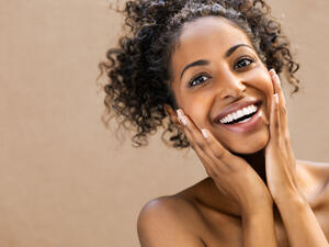 Beautiful young woman smiling after fantastic face treatment