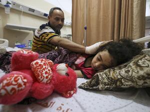 Palestinian Ryad Eshkuntana, checks his daughter Suzy, as they receive medical care at Al-Shifa hospital in Gaza City, on May 19, 2021, after his wife and other children were killed in an Israeli air strike. Deafening air strikes and rocket fire once more shook Gaza overnight and early today amid an international diplomatic push to broker a ceasefire after more than a week of bloodshed