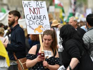 Protesters gathered in Parliament Square on Saturday to protest against the UK vaccination rollout