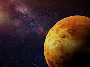 planet Venus in front of a colorful star field 