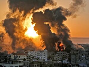 A fire rages at sunrise in Khan Yunish following an Israeli airstrike on targets in the southern Gaza strip, early on May 12, 2021. Israeli air raids in the Gaza Strip have hit the homes of high-ranking members of the Hamas militant group, the military said Wednesday, with the territory's police headquarters also targeted.