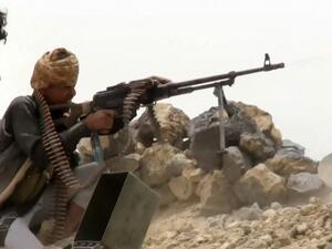 A grab from an AFPTV video shows a fighter loyal to Yemen's Saudi-backed government manning a machine gun at a position near the frontlines against the Huthi rebel forces in the region of al-Kassara,