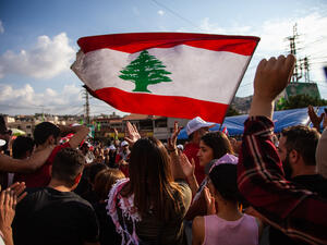 Lebanese Protesters rising Lebanon Flag