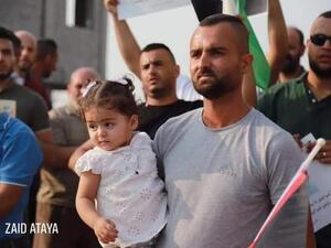 The daughter of Palestinian pregnant detainee Anhar al-Deek, Julia  in protest against her mom 's detention