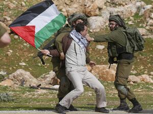 A Palestinian demonstrator detained by Israeli soldiers
