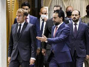 Iraqi Parliament Speaker Muhammad al-Halbousi (R) receives France's President Emmanuel Macron