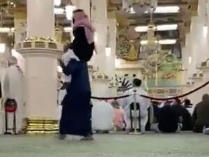 شاب يحمل والده على كتفيه بالمسجد النبوي
