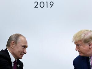 former US President Donald Trump (R) attends a meeting with Russia's President Vladimir Putin during the G20 summit in Osaka on June 28, 2019. (Photo by Brendan Smialowski / AFP) US President Donald Trump