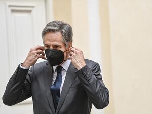 US Secretary of State Antony Blinken puts his face protection mask back on after posing for a group picture during a meeting of the Foreign Ministers of the G7 Nations at the Munich Security Conference (MSC) in Munich, southern Germany, on February 19, 2022. Ina Fassbender / POOL / AFP US Secretary of State Antony Blinken