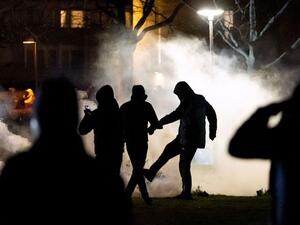 A protester kicks a tear gas canister at Rosengard in Malmo