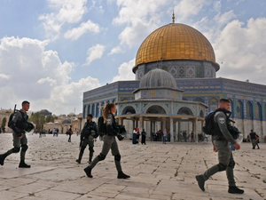 Israeli police walk at the Dome of the Rock mosque
