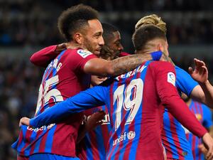Barcelona's Gabonese midfielder Pierre-Emerick Aubameyang (L) celebrates scoring the opening goal during the Spanish League football match between Real Sociedad and FC Barcelona at the Anoeta stadium in San Sebastian on April 21, 2022. (Photo by ANDER GILLENEA / AFP)