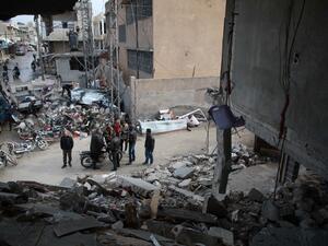 Syrians stand next to a destroyed building in Balyun in Syria's northwestern Idlib province, on December 8, 2019, the day after a reported Russian airstrike on a market in the village. AFP / Aaref WATAD 2019 airstrike in Syria