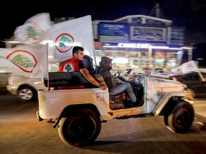 Supporters of the Lebanese Forces party celebrate in the Lebanon's northern coastal city of Batroun as they await results after the end of voting in the parliamentary elections on May 15, 2022. (Photo by Ibrahim Chalhoub / AFP) parliamentary elections