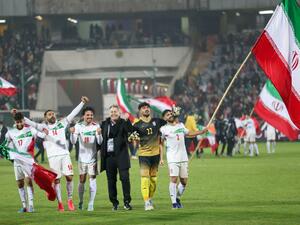 Iran's players celebrate with their fans after qualifying for the 2022 Qatar World Cup after their win against Iraq in the Asian Qualifiers football match at the Azadi Sports Complex in the capital Tehran, on January 27, 2022. (Photo by Atta KENARE / AFP)