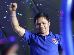 This photo taken on May 7, 2022 shows Philippine boxing icon and presidential candidate Manny Pacquiao raising a clinched fist during a campaign rally in General Santos City, on the southern island of Mindanao. (Photo by AFP)